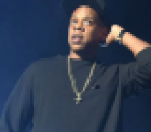 JAY-Z says he and Beyoncé sat during Super Bowl National Anthem because they were working