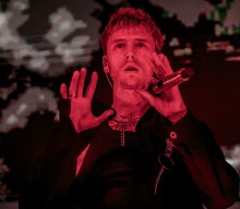 Machine Gun Kelly first met Twenty One Pilots while “peeing in a trash can”