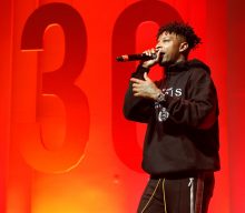 Watch 21 Savage get turned upside down in video for ‘Saw’ soundtrack contribution ‘Spiral’