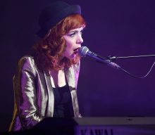 The Anchoress performs with air purifiers as she’s “clinically vulnerable”