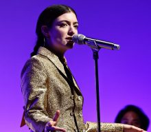 Lorde performs while peeling fruit at the Guggenheim International Gala
