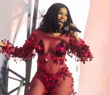Cardi B uses microphone to keep fan at bay during Wireless set