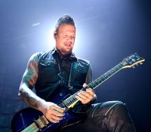 Disturbed’s Dan Donegan gets “fuck cancel culture” painted on his guitar