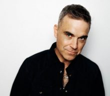 Robbie Williams pulls out same fan at Budapest gig as he did 20 years ago