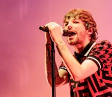 Louis Tomlinson says having the most writing credits in One Direction makes him feel “important”