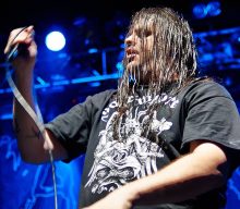 Cannibal Corpse’s Corpsegrinder poses with mall Santa and donates toys to charity